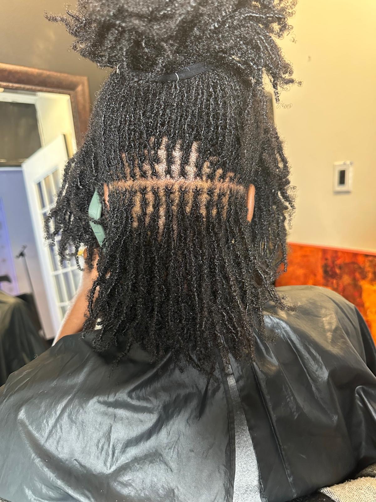 Mini twists with afro puffs and precise parting by Amajoris