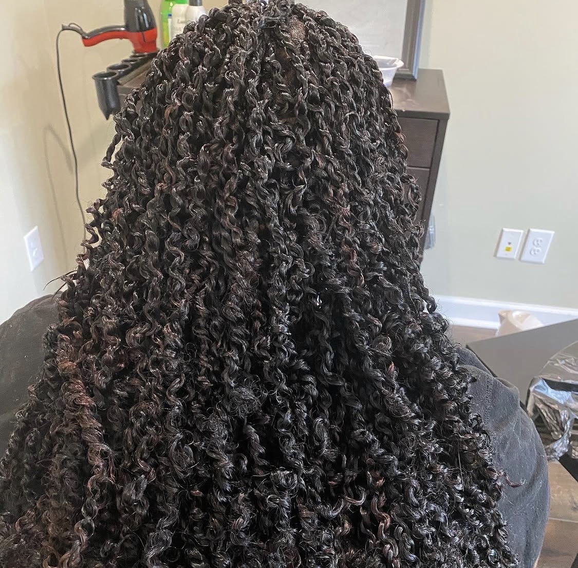 Back view of long passion twists styled by Amajoris