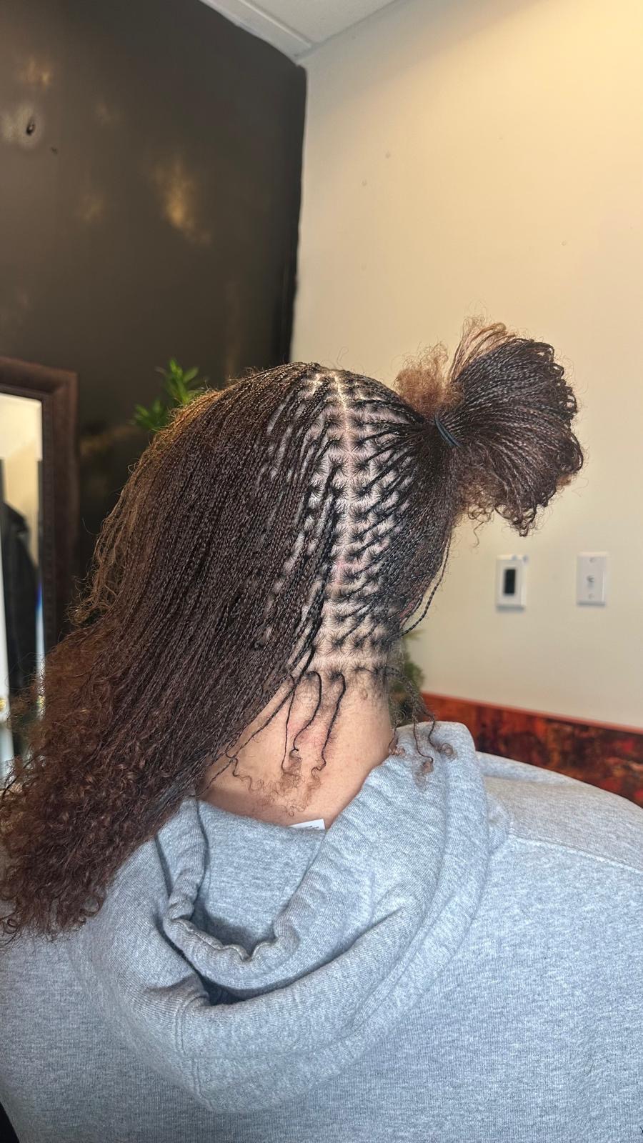 Micro braids with copper ends swept into a bun by Amajoris