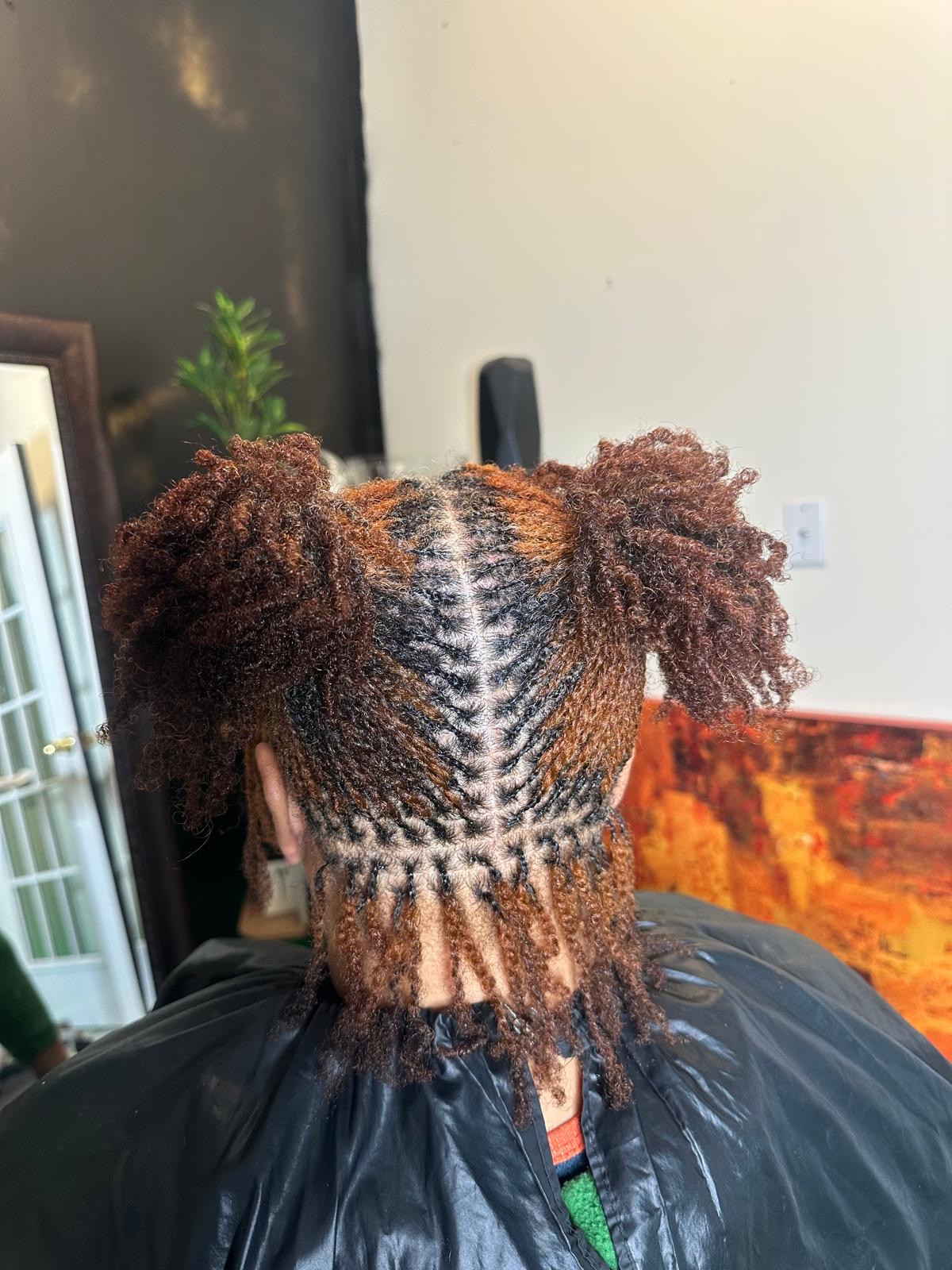 Copper twists styled into two full puffs by Amajoris